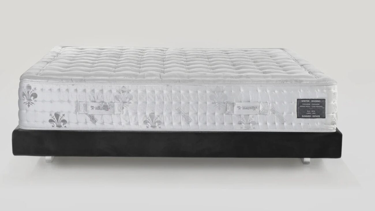 Luxurious white mattress with quilted tufting on sleek black frame; ideal for modern bedrooms.