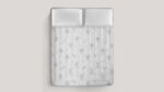 Luxurious tufted mattress with floral patterns, creating an inviting and serene bedroom atmosphere.