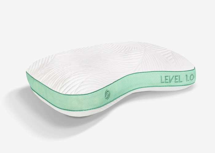 Ergonomic pillow with leaf pattern, turquoise trim, and customizable comfort for optimal head-neck support.