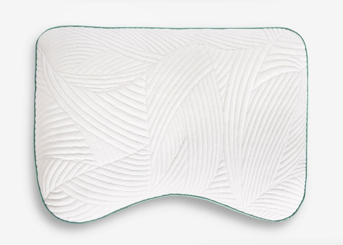 White ergonomic wave pillow with green border, offering stylish comfort and neck support.