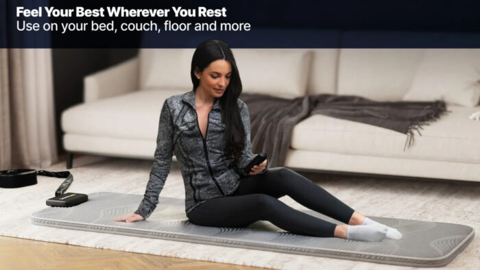 Young woman practicing wellness on ergonomic mat in stylish living room.