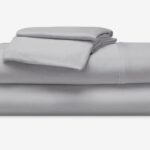 Light grey bed linens, minimalist design, versatile, high-quality fabric for modern bedroom decor.