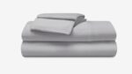 Light grey bed linens, minimalist design, versatile, high-quality fabric for modern bedroom decor.
