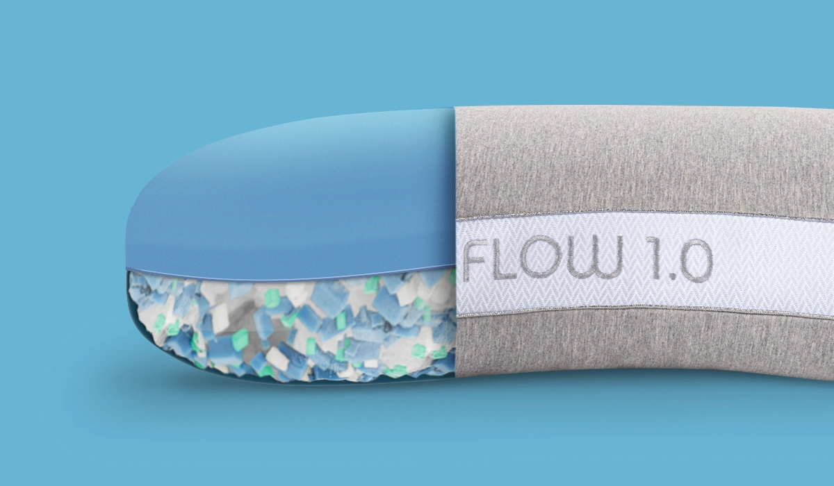 Flow 1.0 device with blue cap, gray padded base, and multi-colored textured underside.