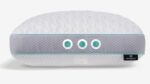 Modern ergonomic elongated pillow with dual-tone design, teal accents, and tactile fabric texture.