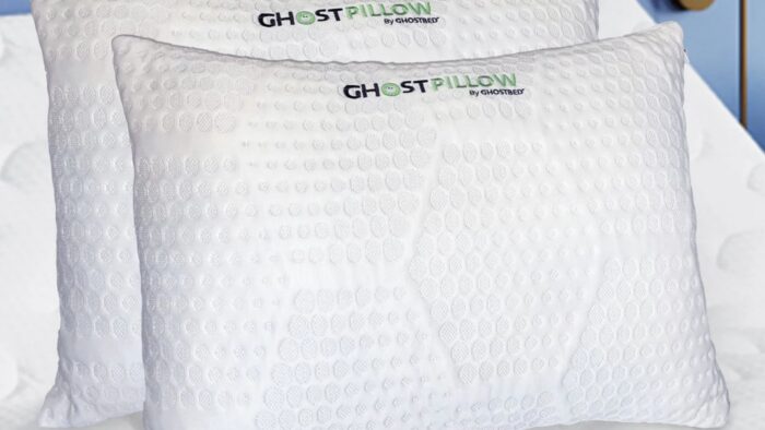 White Ghost Pillow by Ghostbed with cooling texture on a serene, inviting bed.