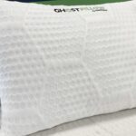 White Ghost Pillow with bubble texture for breathability, surrounded by minimalist white bedding.