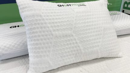 White Ghost Pillow with bubble texture for breathability, surrounded by minimalist white bedding.