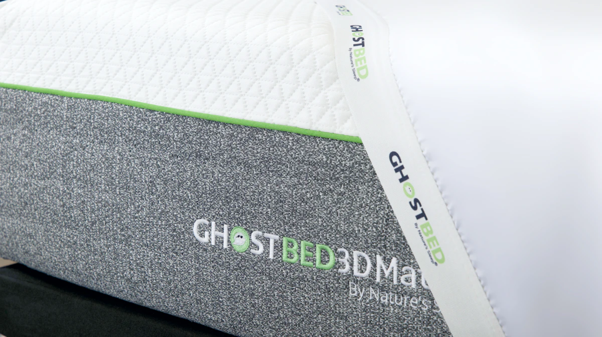 GhostBed 3D Mattress with plush top, textured sides, and green strip for modern comfort.