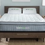 Modern bedroom with GhostBed Flex mattress, wooden frame, and natural light for serene ambiance.