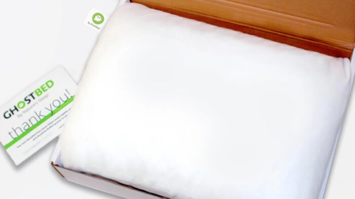 Plush white GhostBed pillow in box with thank you card, showcasing comfort and quality.