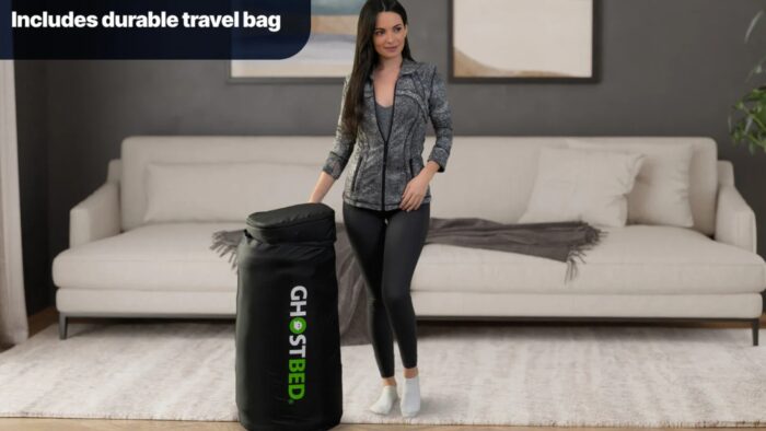 Woman with GhostBed travel mattress in modern, cozy living room setting.