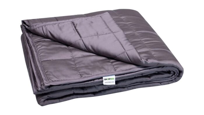 Silky deep purple quilted blanket with luxurious, warm texture and elegant design.