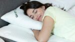 Young woman sleeping peacefully with GhostBed pillow for ultimate comfort.
