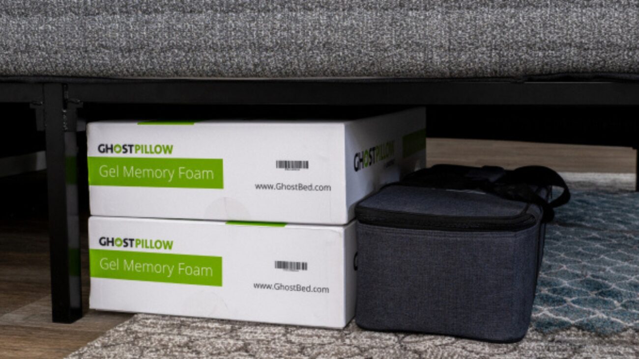 Efficient under-sofa storage with GhostPillow boxes and stylish gray container in a cozy setting.