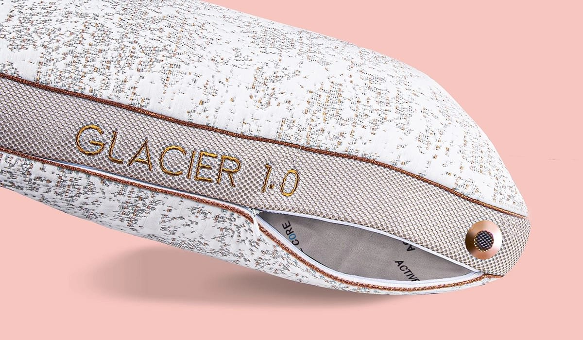 Modern Glacier 1.0 pillow with gold accents, tan trim, and decorative button in peach setting.
