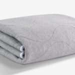 Plush gray fleece blanket with quilted pattern, perfect for modern and cozy decor.