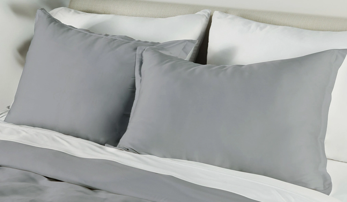 Cozy gray bedding with pillows and duvet for a serene, modern bedroom retreat.