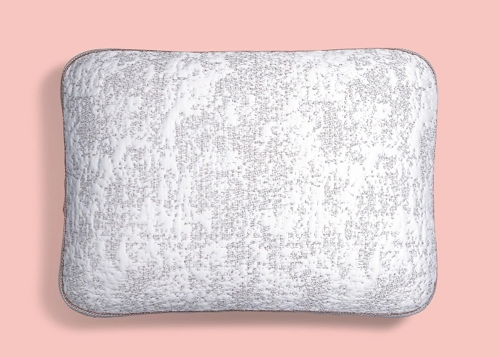 Gray pillow with sophisticated pattern on soft pink background, showcasing modern elegance and comfort.