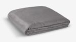 Modern gray quilt with geometric pattern, plush texture, and smooth fabric for versatile decor.