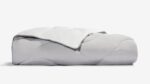 Plush gray comforter with minimalist design, enhancing bedroom decor with warmth and elegance.