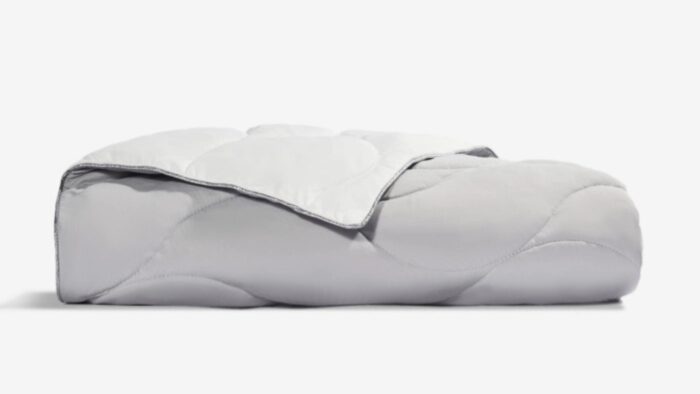 Plush gray comforter with minimalist design, enhancing bedroom decor with warmth and elegance.