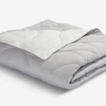 Soft grey quilted comforter for warmth and style in any bedroom or living space.