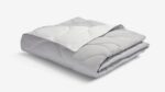 Soft grey quilted comforter for warmth and style in any bedroom or living space.