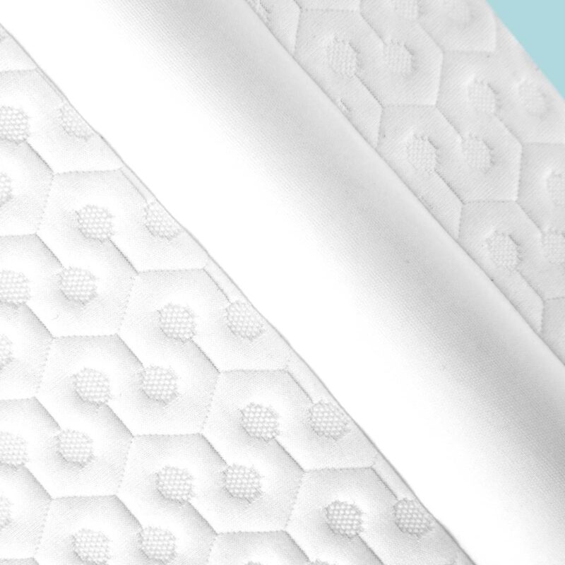Close-up of white honeycomb fabric with hexagonal pattern, ideal for modern home decor.