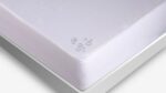 Water-resistant white mattress with modern design, rounded edges, and quality craftsmanship.