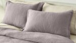 Lavender bedding with textured pillows for a cozy, modern, calming sleep environment.