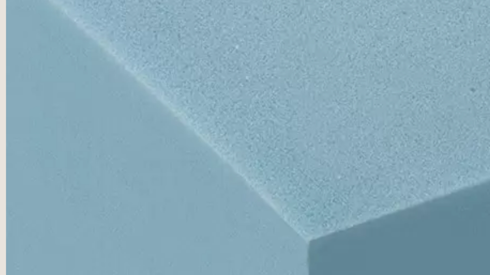 Close-up of a smooth, matte light blue surface, evoking calm and minimalist design.