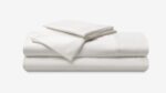 Luxurious white bed linens set for a serene and inviting bedroom atmosphere.