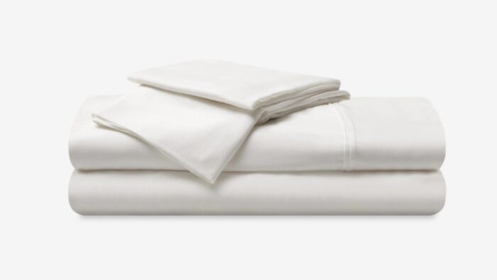 Luxurious white bed linens set for a serene and inviting bedroom atmosphere.