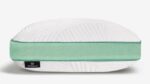 Modern pillow with curved design, mint green accents, and embossed textured white surface.