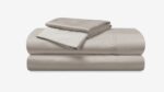 Elegant beige bedding set with quality fabric, minimalist design, promoting tranquility in bedrooms.