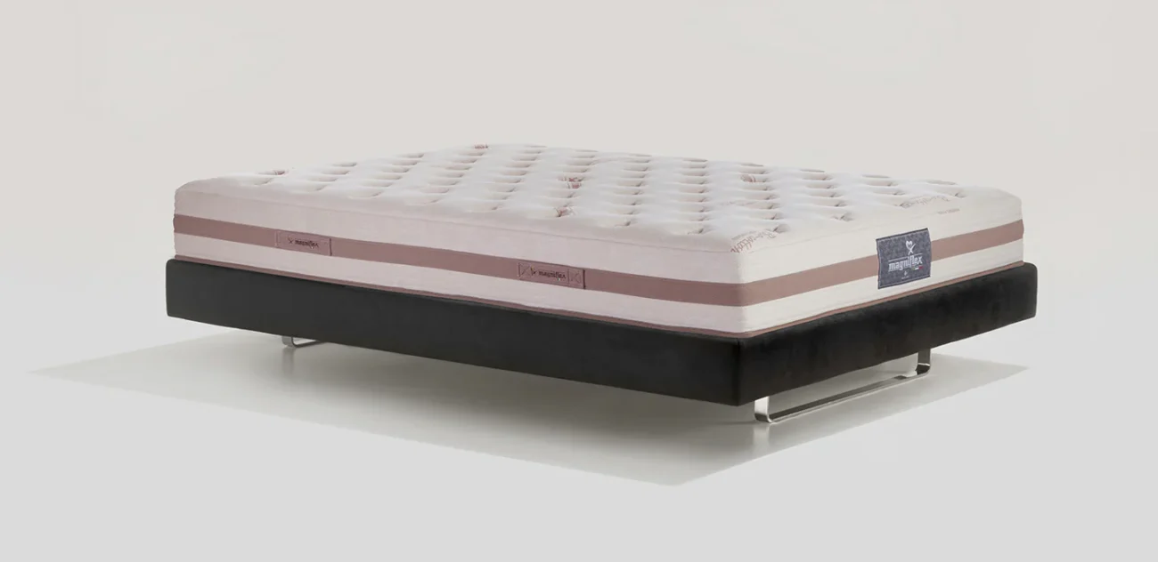 Plush cream and pink mattress on a sleek black modern bed frame, luxurious and comfortable.