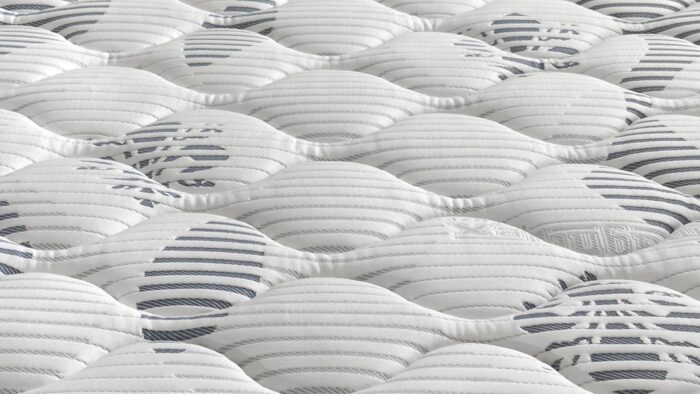Modern mattress with stylish wavy patterns, white and gray tones, offering comfort and quality.