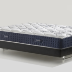 Luxurious modern mattress with quilted design, navy-blue border, and sleek metal frame.