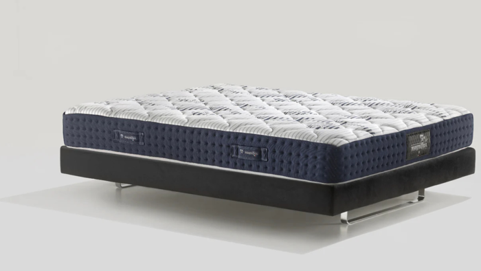 Luxurious modern mattress with quilted design, navy-blue border, and sleek metal frame.