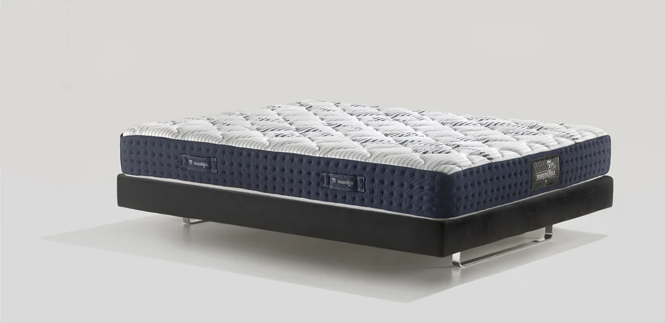 Modern mattress with quilted top on minimalist sleek black frame.