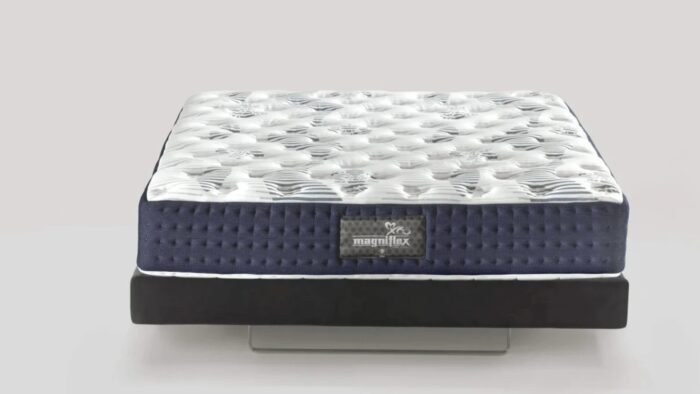 Modern hybrid mattress with quilted top, navy sides, and black foundation for comfort and style.