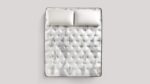 Luxurious white quilted mattress with plush pillows for ultimate comfort and relaxation.