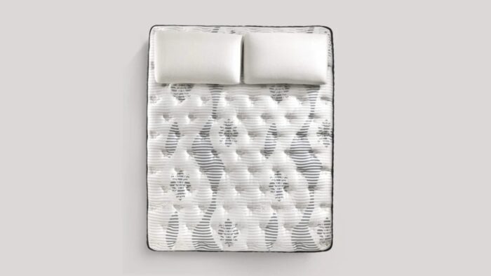 Luxurious white quilted mattress with plush pillows for ultimate comfort and relaxation.