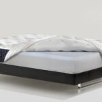 Modern luxury mattress with memory foam on a sleek black frame for optimal comfort.