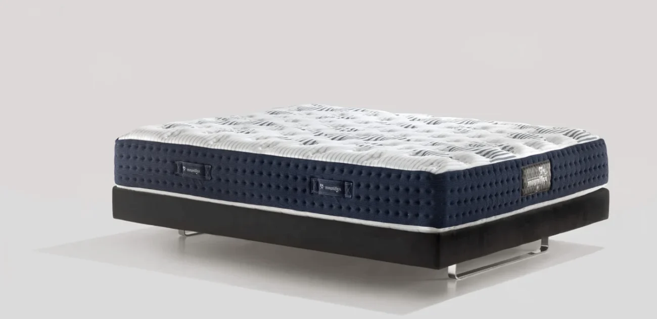 Modern mattress with quilted top, breathable sides, and sleek black base for elegant bedrooms.