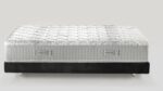 Luxurious plush mattress with diamond stitching, sleek black base, and practical handles.