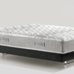 Luxurious quilted mattress with modern black box spring for ultimate comfort and style.
