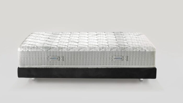 Luxury quilted mattress with side handles and black base for modern bedroom support.