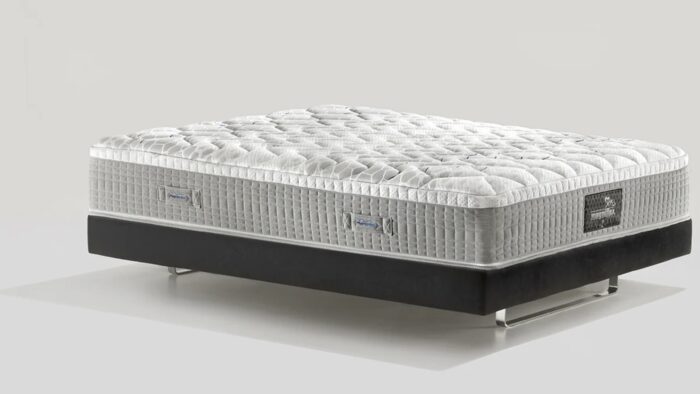 Luxurious modern mattress with plush quilting on a sleek, contrasting platform base.